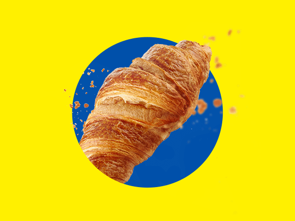 Kuldne, krõbe croissant kollasel taustal sinise ringiga.