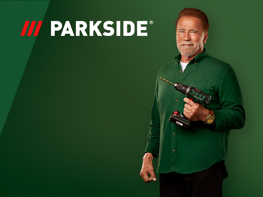 Arnold Schwarzenegger hoiab Parkside'i akutrelli rohelisel taustal.